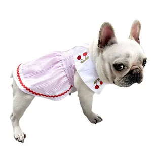 Pink striped pet dress with cherry embroidery shown on a white French Bulldog model