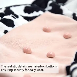 Close-up of Halloween cow dog costume featuring secure teat button details on soft plush