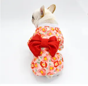 Back view of a dog wearing a floral Japanese kimono with a large red bow detail