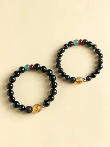 Close-up detail of new Chinese style obsidian and citrine beaded couple bracelets.