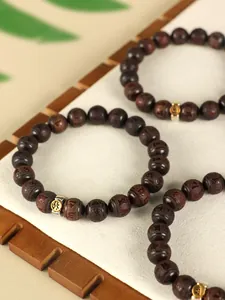 Macro view of Chinese zodiac red sandalwood beaded bracelets with metal charms