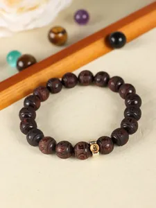Detailed view of the handcrafted small-leaf red sandalwood beaded bracelet with zodiac carvings.