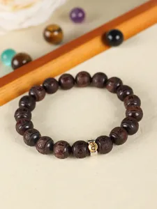 Close-up detail of carved red sandalwood beads on an ethnic style vintage bracelet.