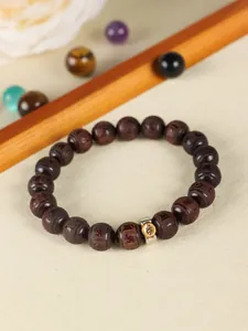 Close-up detail of Lobular Rosewood beaded bracelet featuring intricate zodiac carvings