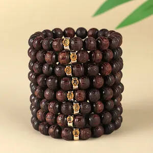 Stack of vintage red sandalwood bead bracelets with zodiac Buddhist metal charms