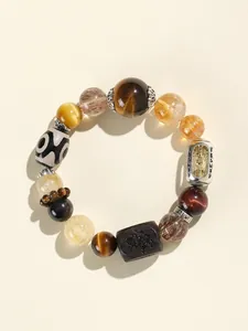 Detailansicht eines Multistein-Perlenarmbands mit Tigerauge- und Dzi-Schmuckperlen