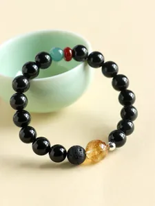 Detailed view of Neo-Chinese obsidian bracelet with citrine and agate accent beads