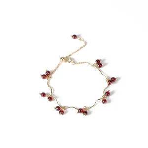 Elegante bracciale con perle di granato rosso vino e una catena dorata dallo stile minimalista