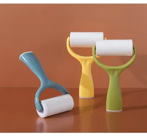 Three colorful standing lint rollers in blue, yellow, and green for clothing hair removal