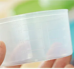 Detailed close-up of clear plastic measuring cup lid featuring precise 180cc scale markings