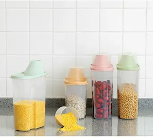 Four clear plastic kitchen storage canisters for grains and dry food with colored lids
