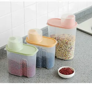 Detail of three assorted sizes of transparent cereal storage containers on a kitchen counter