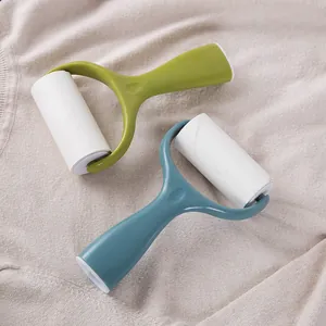 Two manual lint rollers for clothes on a beige knitted sweater background.