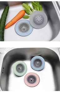 Detailed view of colorful silicone kitchen sink strainers in a stainless steel sink