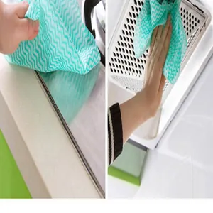 Detail showing wave pattern disposable non-woven cleaning cloth wiping kitchen surfaces.