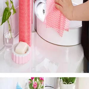 Close-up of pink wave pattern disposable non-woven dishcloth cleaning white sink