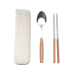 Portable stainless steel cutlery set with wooden handles and speckled beige storage box