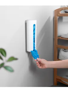 Wall-mounted white storage box dispenser for plastic bags or shoe covers in detail