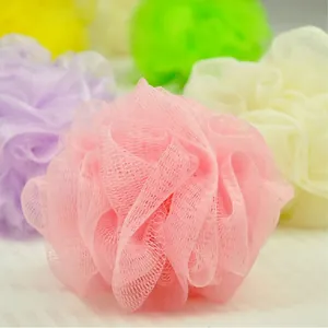 Macro detail of the soft nylon mesh texture on a pink bath loofah sponge ball