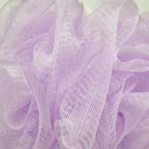 Macro detail of a soft purple nylon mesh bath ball showing fine foaming texture and material.