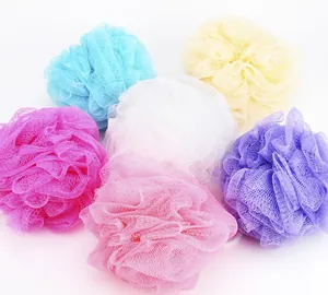 Macro detail view showing various colorful nylon bath sponges with soft mesh texture