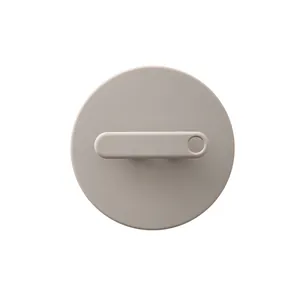 Minimalist round silicone body scrubber with ergonomic finger strap for painless exfoliation