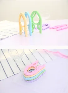 Compact folding travel hangers in pastel colors, showing folded and storage states.
