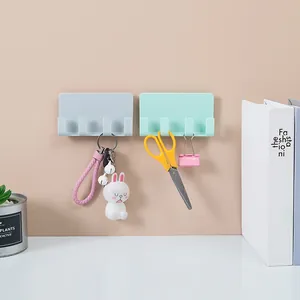 Multifunctional adhesive wall-mounted phone charging stand with four hooks in pastel colors