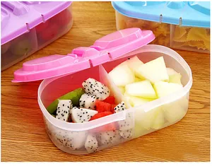 Detailed view of a dual-compartment plastic food container filled with fresh cut fruits