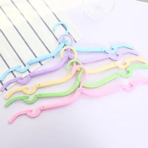 Five colorful portable folding travel clothes hangers in vibrant pastel shades
