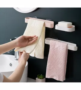 Detail view of wall-mounted ABS towel racks and soap dish in a bathroom setting