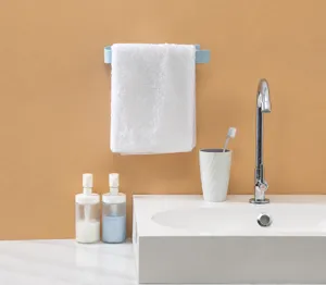 Wall-mounted adhesive towel rack showing practical usage in a modern bathroom scene