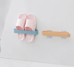 Detail of wall-mounted multi-functional storage rack organizing slippers in bathroom