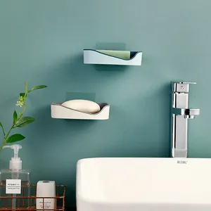 Two minimalist wall-mounted adhesive drainage soap dishes shown in a modern bathroom scenario