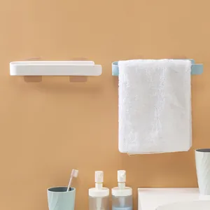 Minimalist white and blue adhesive wall-mounted towel racks in a tidy bathroom setting.