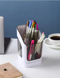 Close-up of slanted desktop organizer with pens and stationery in a modern office setup