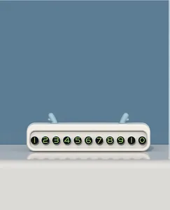 Close-up of a white temporary car parking number plate with green glowing digits.