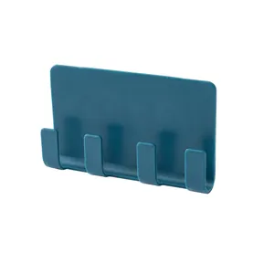 Dark blue wall-mounted four-prong storage hook for razors and plugs in bathroom