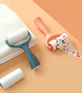 Action shot of standable lint roller removing colorful debris from a white adhesive sheet