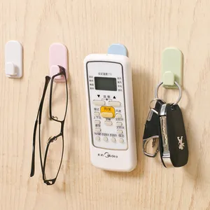 Set of four colorful self-adhesive wall hooks for organizing home keys and remotes