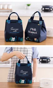 Insulated navy blue lunch bag with cute cat pattern shown in a kitchen setting
