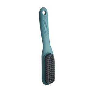 Teal laundry and shoe brush with soft bristles and long ergonomic handle for cleaning.