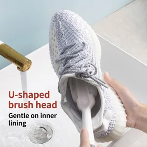 U-shaped long handle shoe brush for gentle interior cleaning in white sink