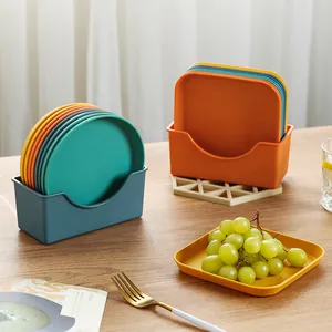Set of colorful plastic snack plates and bone spit saucers with storage holders