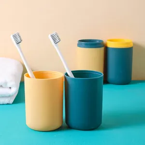 Portable travel wash cup set with toothbrush holders in vibrant teal and yellow colors