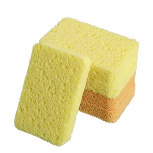 Stack of yellow and orange wood pulp cellulose sponges for kitchen dishwashing and cleaning