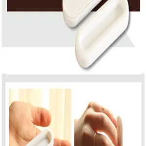 Detailed view of the adhesive door handle showing hand-held size and ergonomic shape