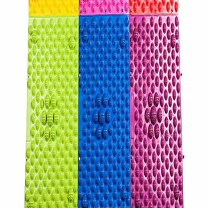 Detailed view of colorful textured acupressure mats for foot massage therapy