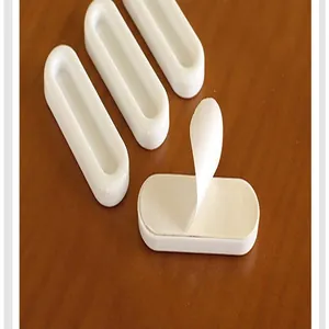 Detail of white adhesive auxiliary handle showing easy-to-peel backing layer