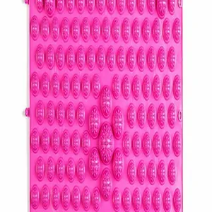 Close-up of pink acupressure massage mat with textured nodes for foot reflexology